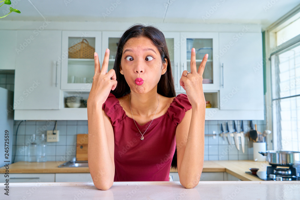 Beautiful woman posing - peace sign gesture and making a face Beautiful woman posing - peace sign gesture and making a face