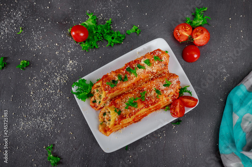 Cannelloni with spinach and ricotta meat tomato sauce photo