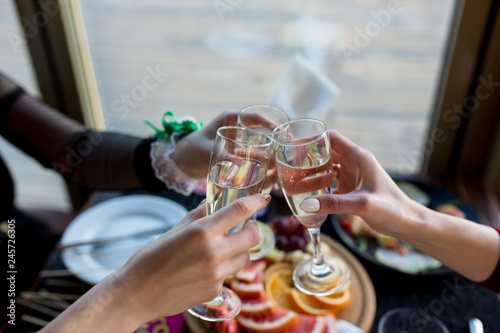 Friends celebrating bachelorette party with glass of champagne