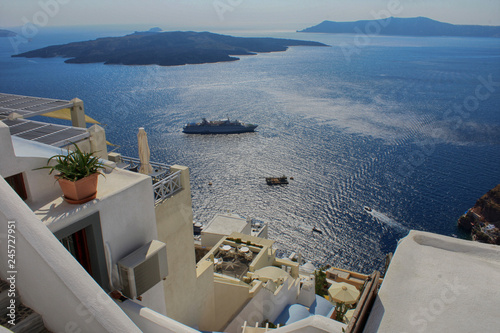 View off the coast of Santorini, the city of Tira and the Aegean Sea in Greece © yanakoroleva27