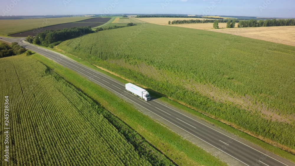 Aerial Top View of White Truck with Cargo Semi Trailer Moving on Road in Direction