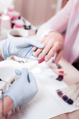 Nice professional nail master trying on the colour