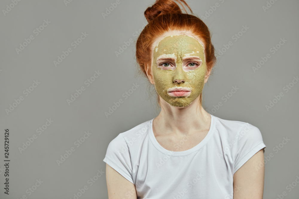 unhappy housewife with green face. close up portrait. isolated grey background. copy space unhappy housewife with green face. close up portrait. isolated grey background. copy space