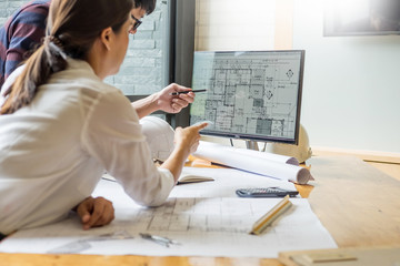 professional architect designer structural engineer team colleagues working office looking computer discussing building plan design project.
