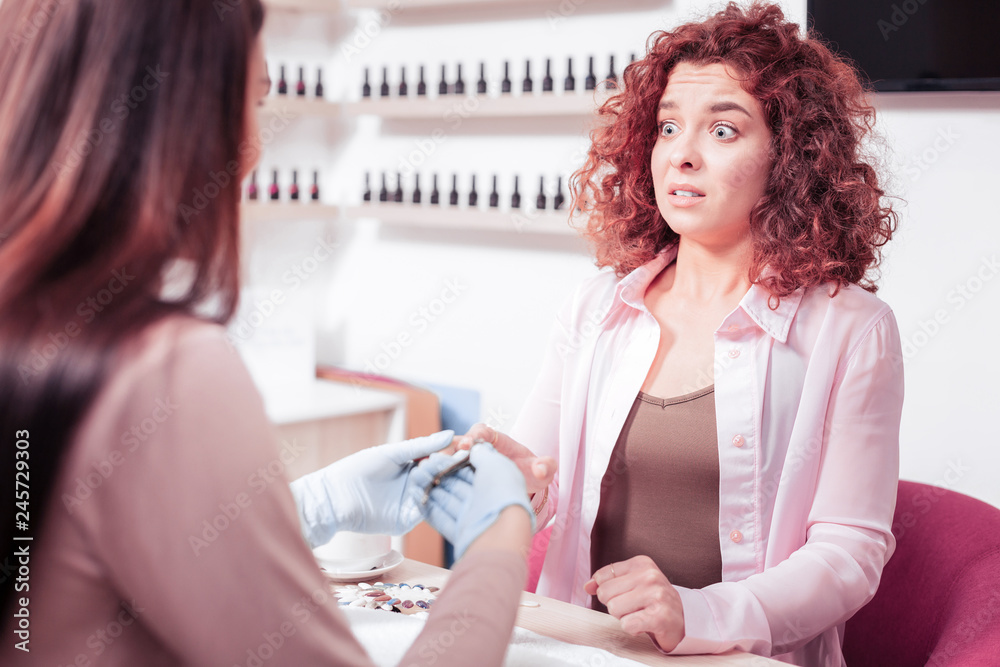 Unhappy young woman feeling pain in the hand Unhappy young woman feeling pain in the hand