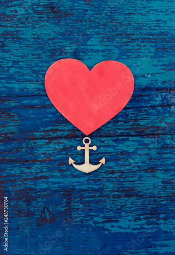 valentine's day,wedding,anniversary card/red heart  and anchor on blue rusty wooden background photo