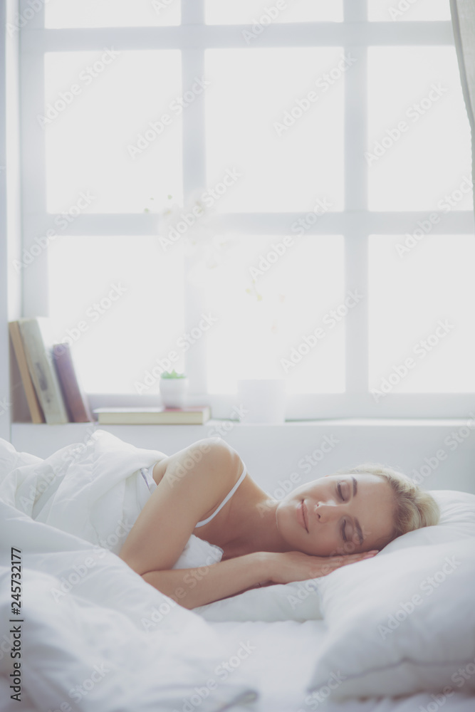 Pretty woman lying down on her bed at home Pretty woman lying down on her bed at home