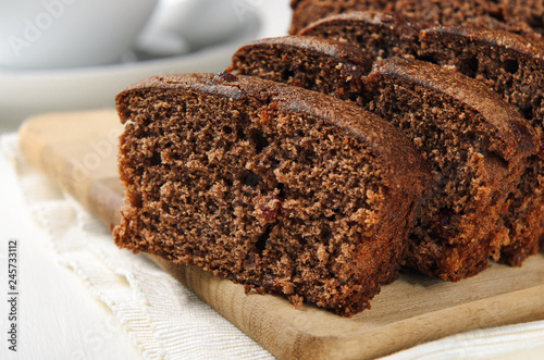 Chocolate muffin sliced on a wooden table. Sweet pastries for breakfast