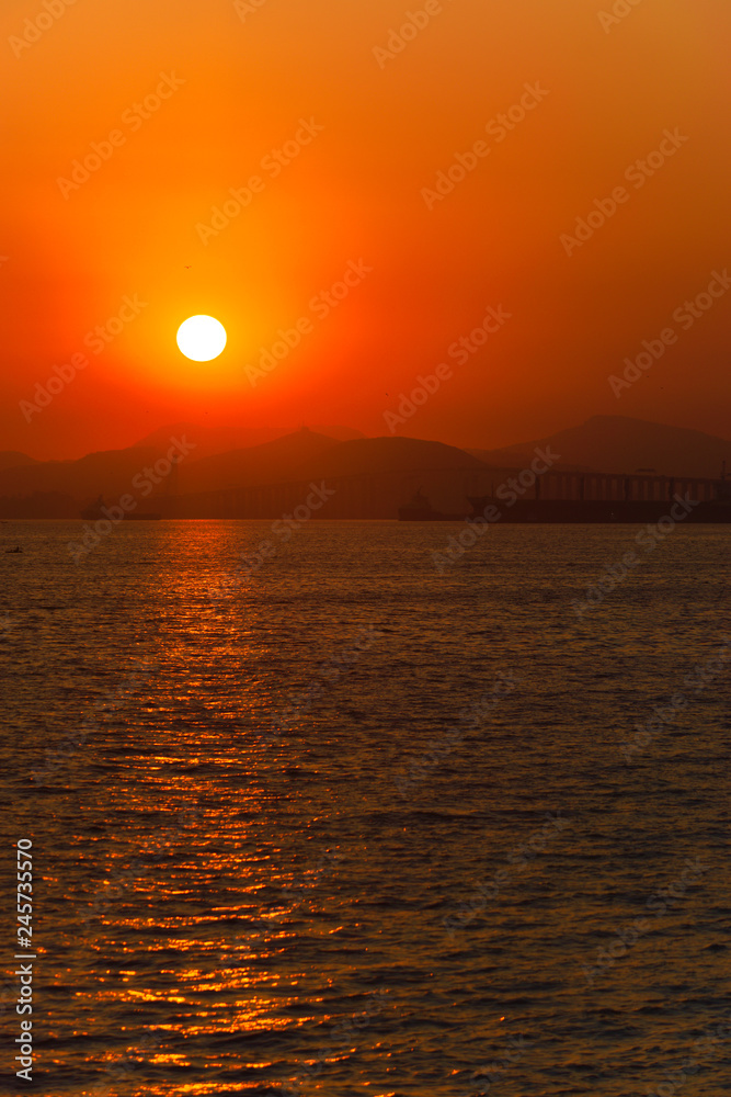 sunrise with sea and landscape in the background