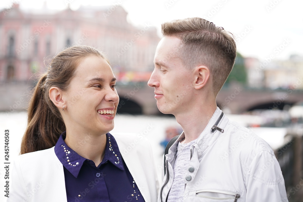 charming good couple husband and wife walking around the city, hugging and spending time with love