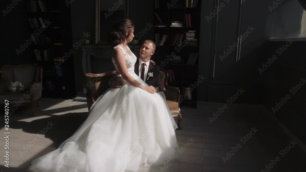 young couple in love man and woman in a wedding dress in the interior young couple in love man and woman in a wedding dress in the interior