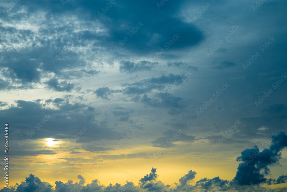 Sunset with sun rays, sky with clouds and sun.