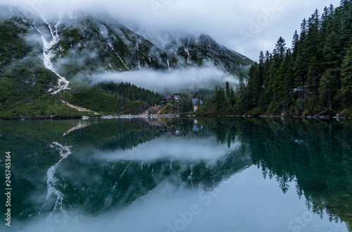lake in the mountains with wooden shelter