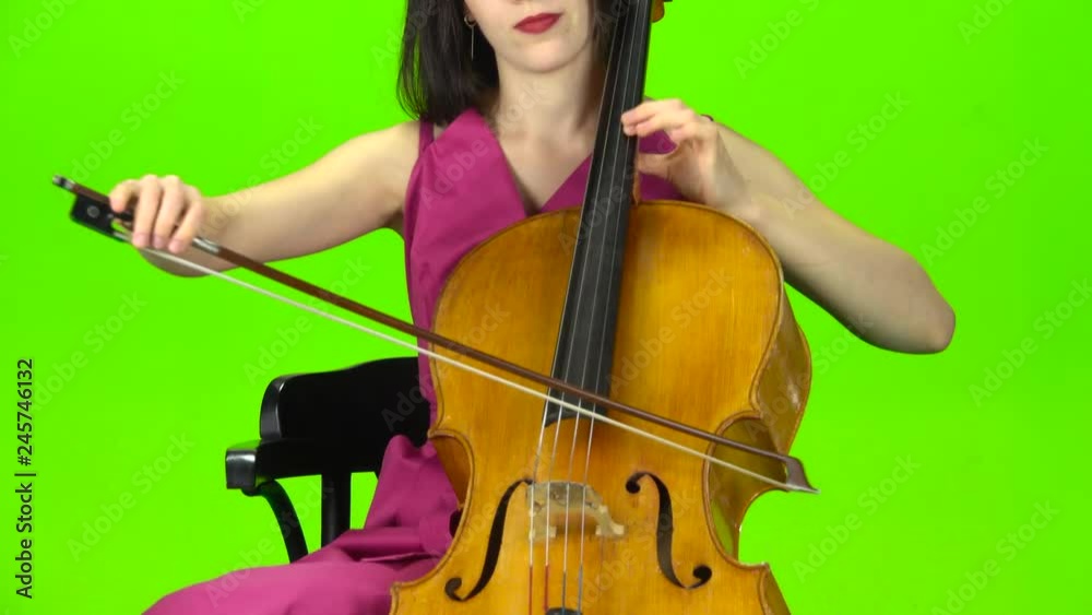 Musician bows the strings of the violin. Green screen Musician bows the strings of the violin. Green screen