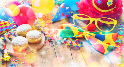 Colorful carnival or party background with donuts, balloons, streamers and confetti and funny face