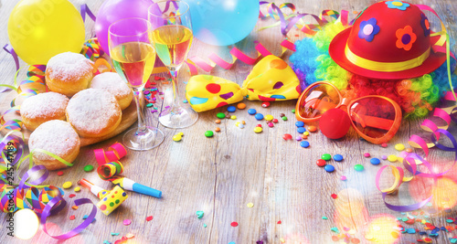 Colorful carnival or party background with donuts, balloons, streamers and confetti and funny face