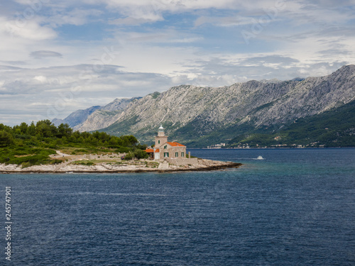 Ferry passing close to Sucuraj lighthouse on Hvar island, Croatia