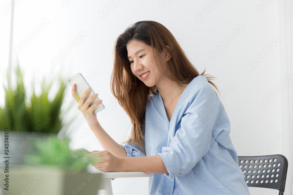Asian women are paying through smartphones and credit card Asian women are paying through smartphones and credit card