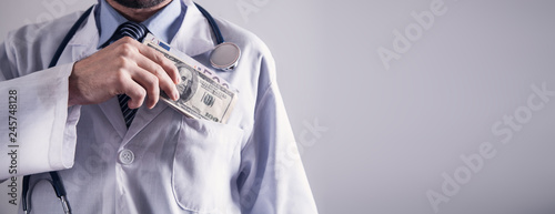 Doctor holding money. Concept of corruption.