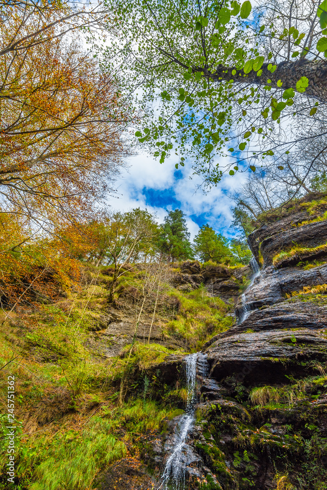 Uguna falls in the forest in Otzarreta mountains park in autumn Uguna falls in the forest in Otzarreta mountains park in autumn