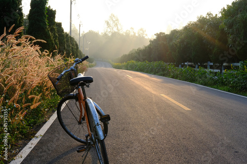 bicycle parking beside road with morning sunrise
