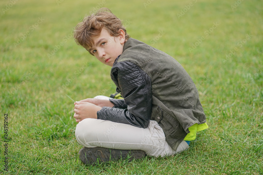 sad lonely boy in the park sitting unhappy sad lonely boy in the park sitting unhappy
