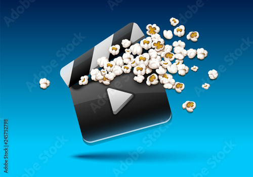 Cinema clapper with popcorn pouring out. Movie film concept.