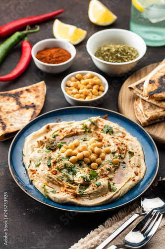 Classic Hummus with chickpeas, paprika, olive oil and oriental spices. Mediterranean popular snack of chickpeas and tahini pasta.