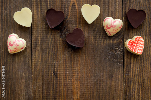 Heart-shaped confection for Valentine's day on dark wooden background top view space for text