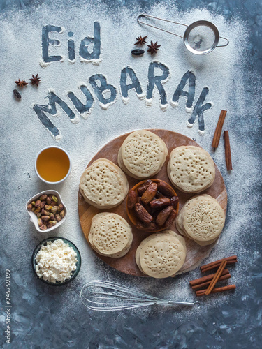 Eid Mubarak - Islamic holiday welcome phrase " happy holiday", greeting reserved. Arabic baking background.