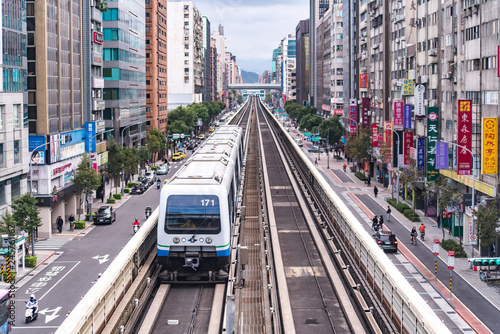 Taipei, Taiwan - January 27, 2019 : Taipei Metro Wenhu Line (Known as The Muzha Line Before Oct, 8, 2009). The Train Runs on Elevated Rails While Other Cars Jammed on The Roads.