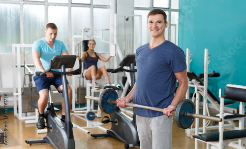 Man doing exercises with barbell