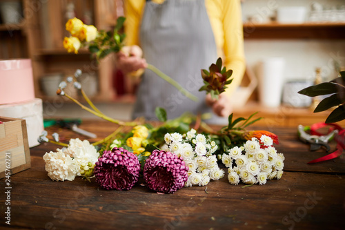 Closeup of assorted flowers lying on counter in flower shop, copy space