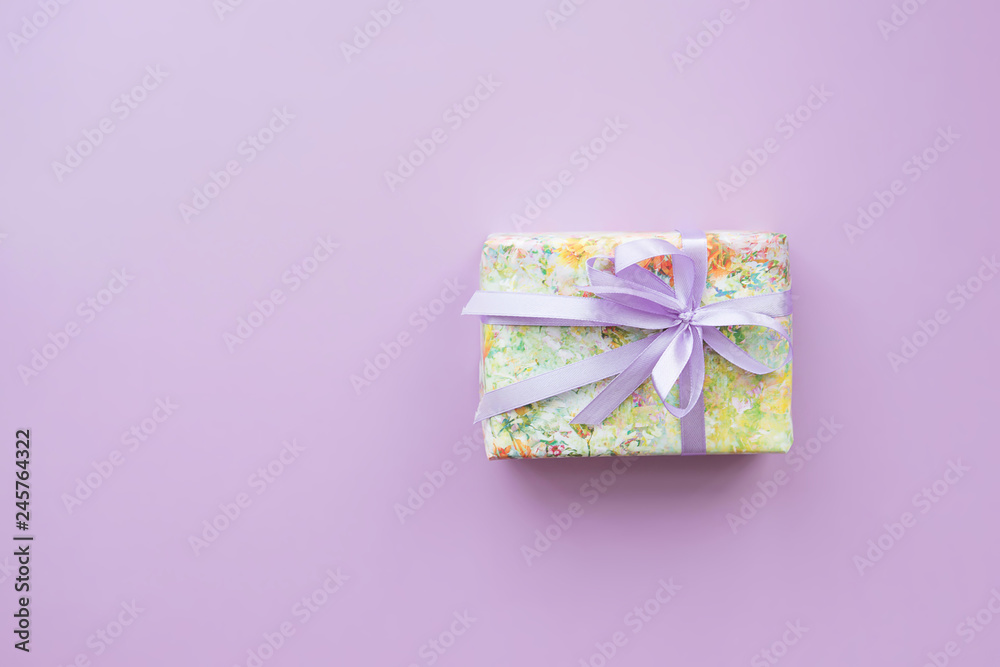 Wrapped gift box with purple ribbon. Wrapped gift box with purple ribbon.