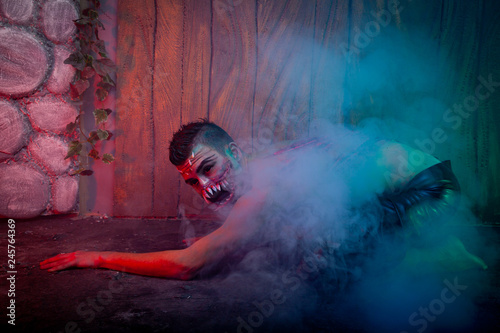 Bild auf Leinwand scary vampire male with huge teeth and bloody body as halloween body art standin