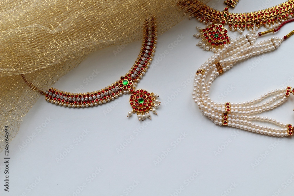 Indian decorations for dancing: earrings, gold scarf and decoration on the neck and on the head. Indian classical dance style bharatanatiam. White background.