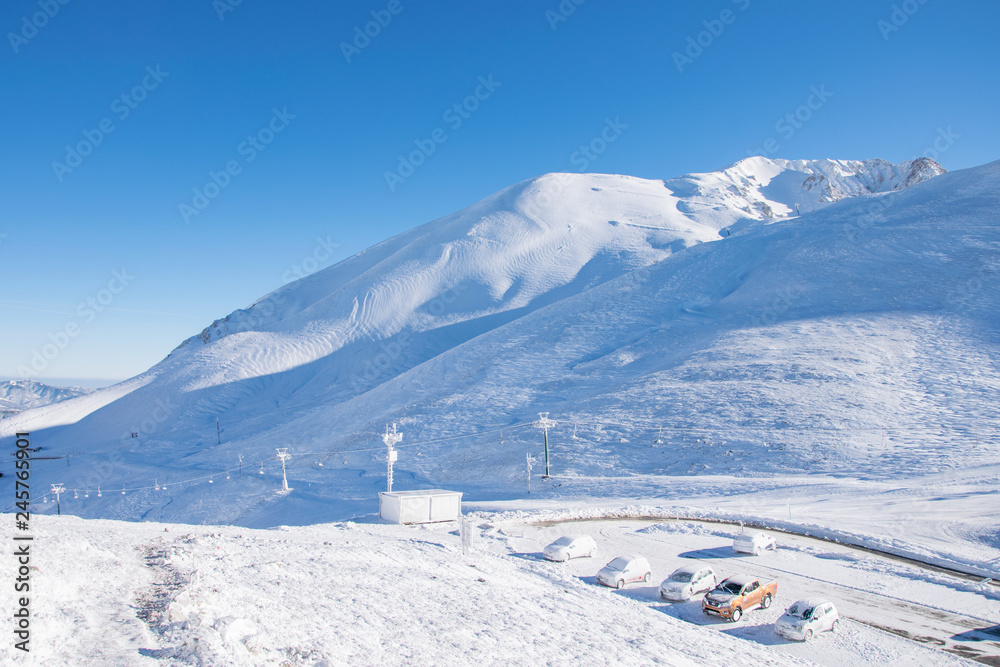 View of the snow covered mountains of Evritania from Velouchi mountain shelter in Greece