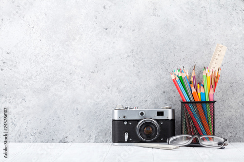 Loft home office workplace with supplies and camera photo