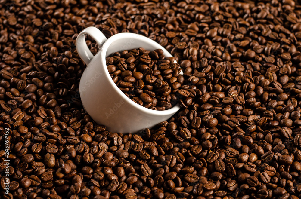 coffee beans background with white cup, copy space coffee beans background with white cup, copy space