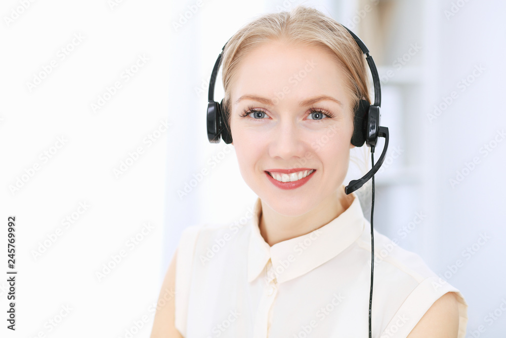 Bright and sunny call center. Group of blonde women in headset at work. Office and business concept Bright and sunny call center. Group of blonde women in headset at work. Office and business concept