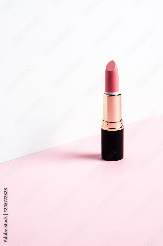 Pink lipstick on a pale background Pink lipstick on a pale background