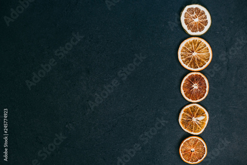 Pieces of fruits arranged in a line on a black background.