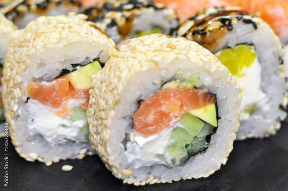 Sushi set: sushi roll with salmon and sushi roll with smoked eel, selective focus.