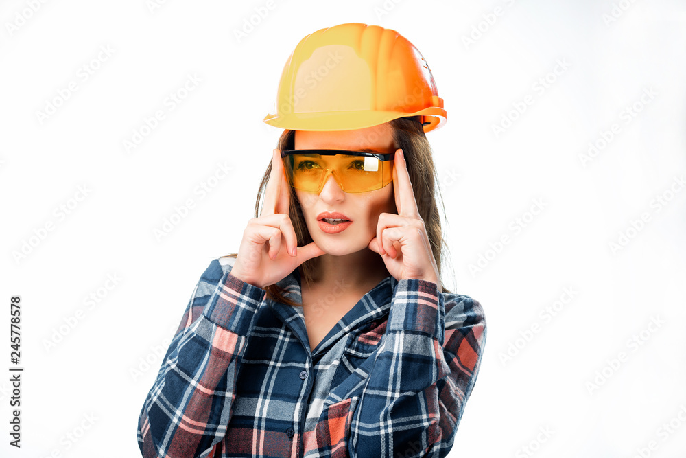 Pretty woman wearing orange protective helmet and glasses having headache and holding fingers on head isolated on white background. Tired female builder in safety helmet Pretty woman wearing orange protective helmet and glasses having headache and holding fingers on head isolated on white background. Tired female builder in safety helmet