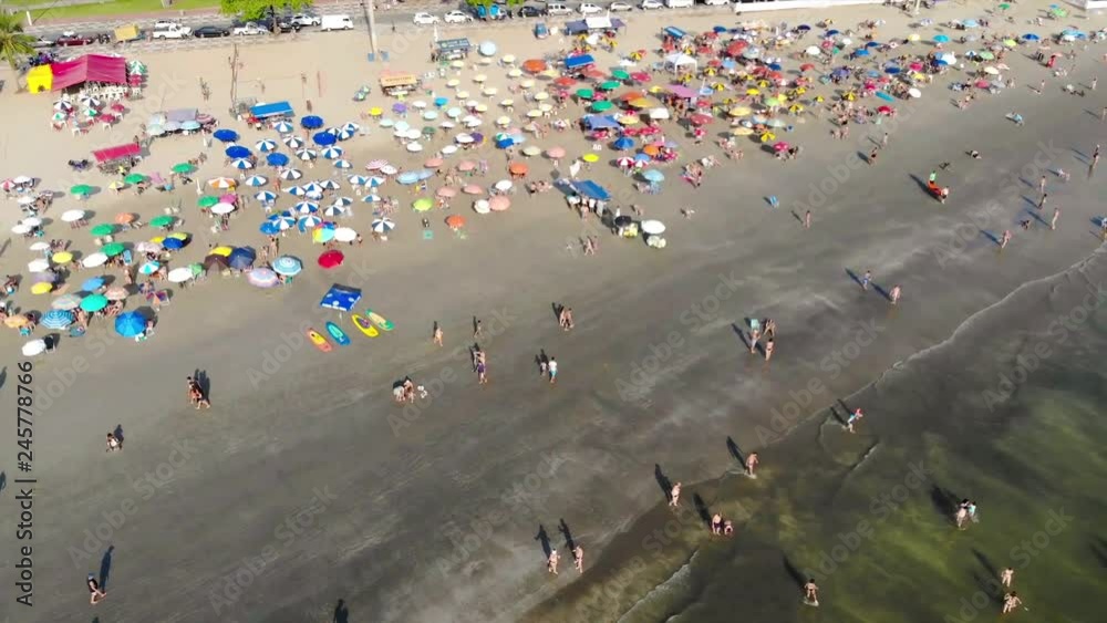 A Busy Beach with Colorful Umbrellas and people in water - Top View - Dolly Forward A Busy Beach with Colorful Umbrellas and people in water - Top View - Dolly Forward