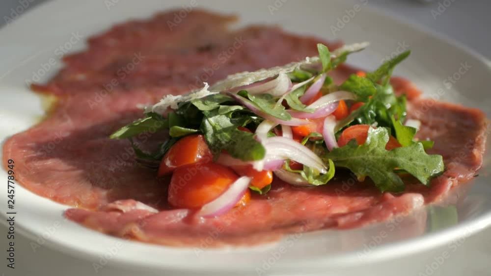 Beef carpaccio with arugula and parmesan cheese Beef carpaccio with arugula and parmesan cheese