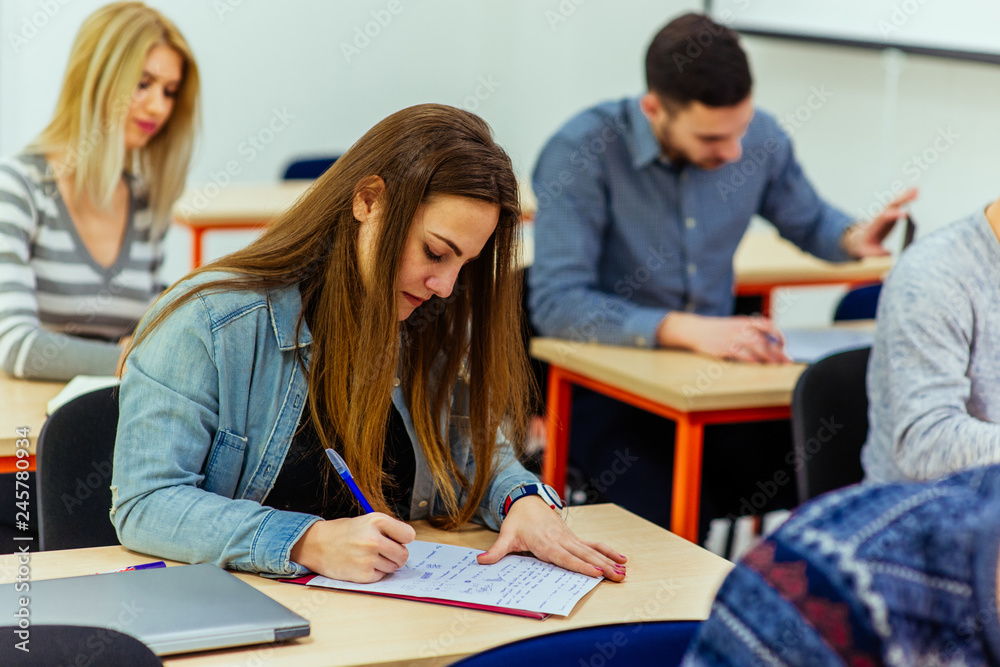 Student taking notes from books for her study