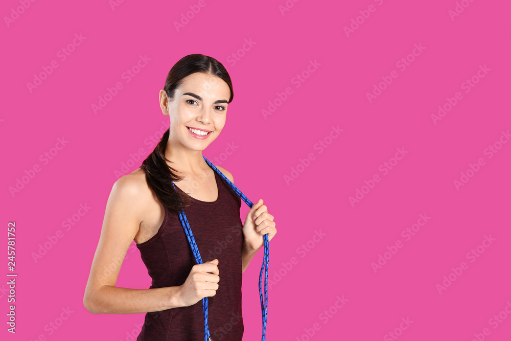 Portrait of young sportive woman with jump rope on color background. Space for text Portrait of young sportive woman with jump rope on color background. Space for text