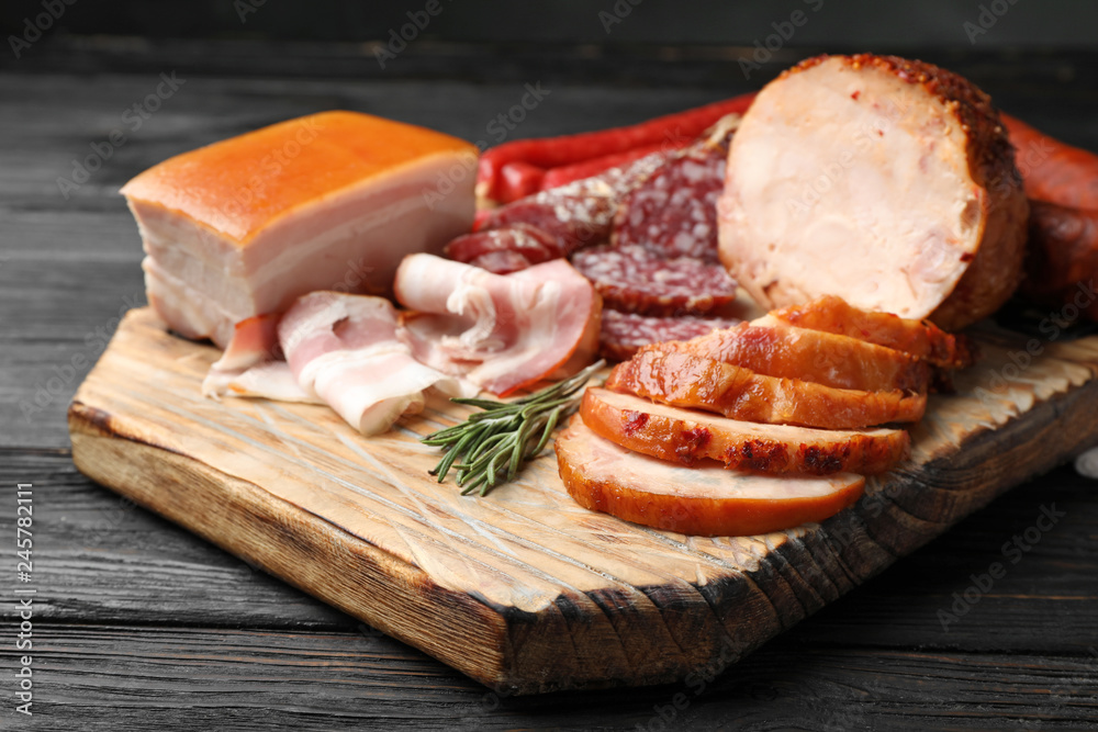 Cutting board with different sliced meat products served on table Cutting board with different sliced meat products served on table