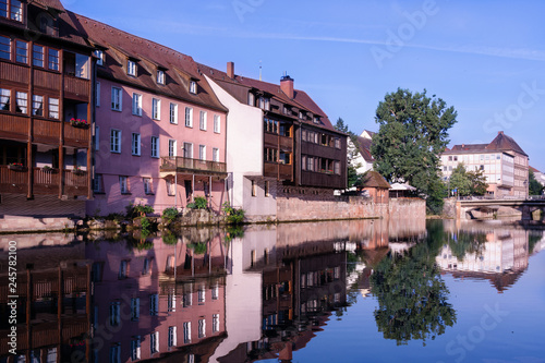 Fototapeta Naklejka Na Ścianę i Meble -  A number of houses stand on the banks of the Pegnitz River in Nuremberg Germany.
